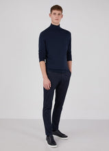 Load image into Gallery viewer, Model wearing Sunspel Merino Roll Neck Jumper in Light Navy.
