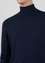 Load image into Gallery viewer, Model wearing Sunspel Merino Roll Neck Jumper in Light Navy.
